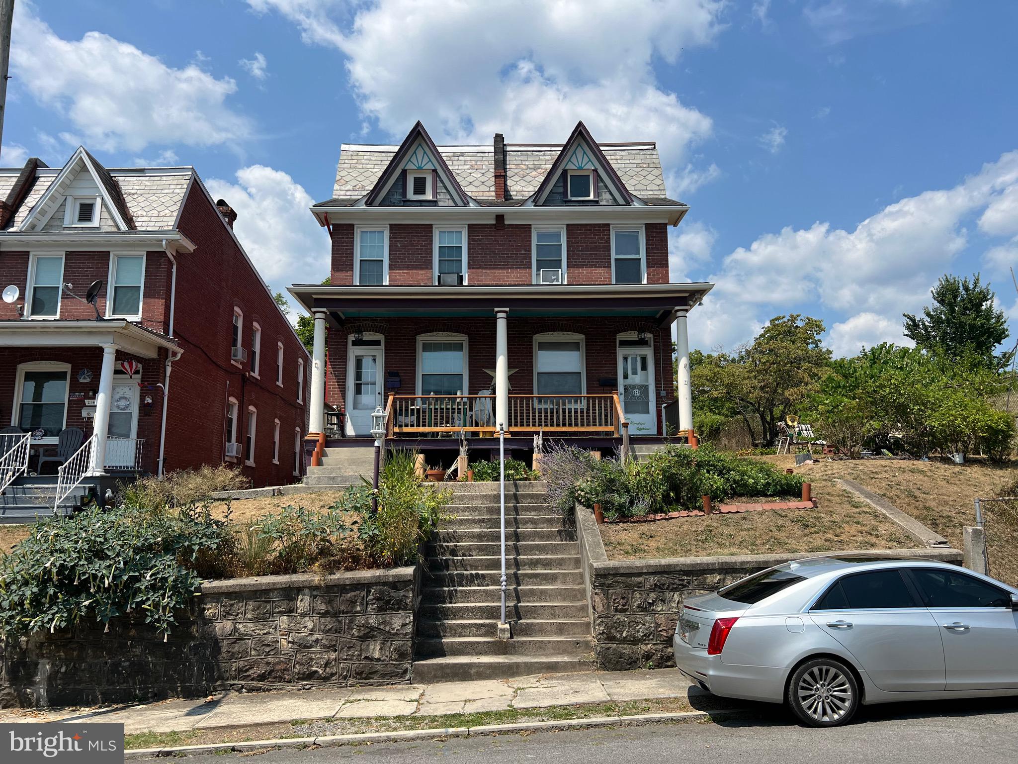 a front view of a house with car parked