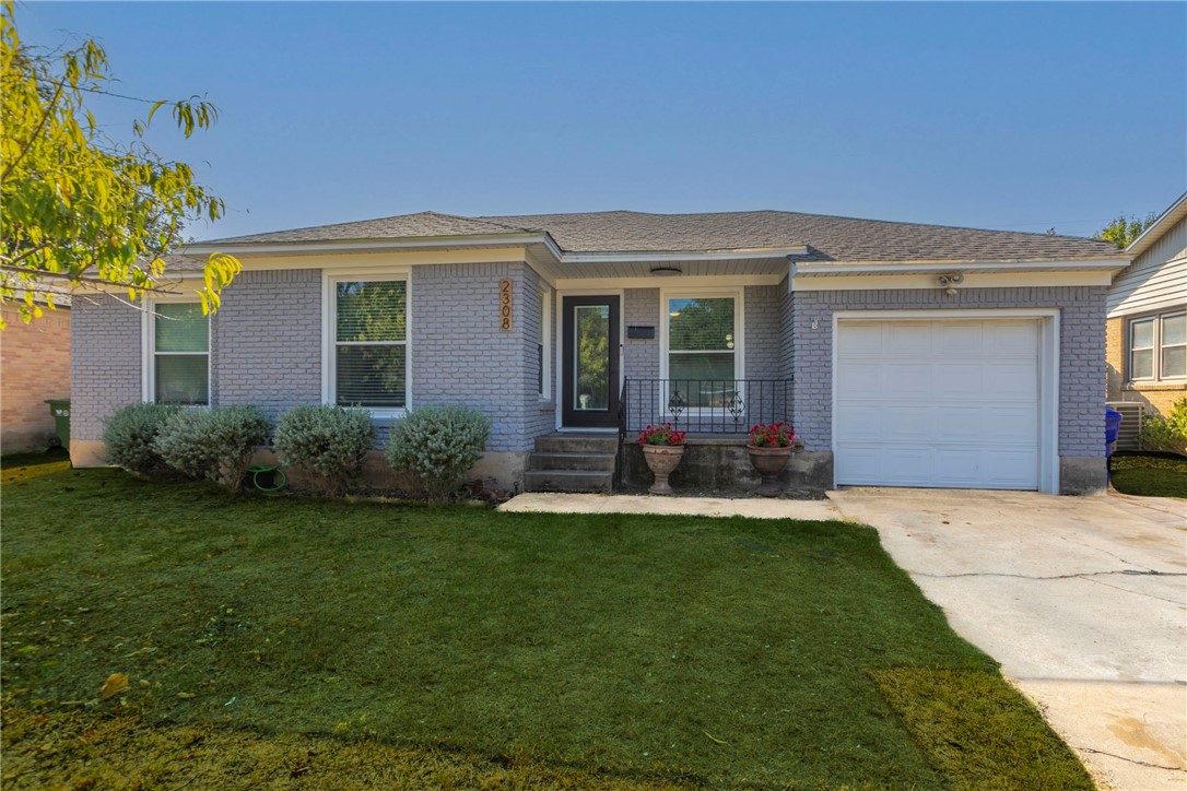 a front view of a house with a yard and porch