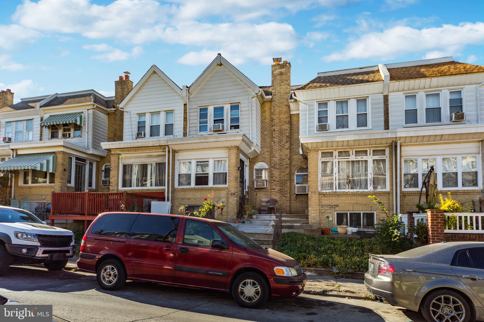 a front view of a house with parking space