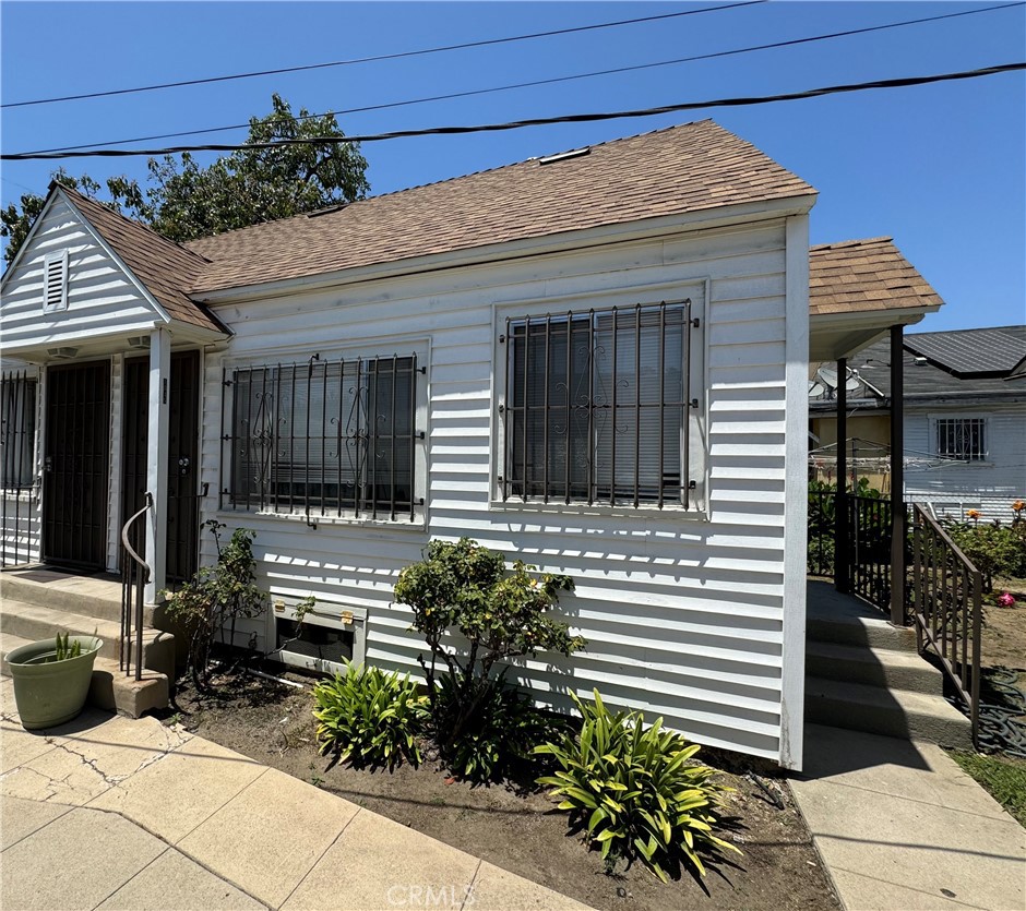 a view of house with chairs in patio