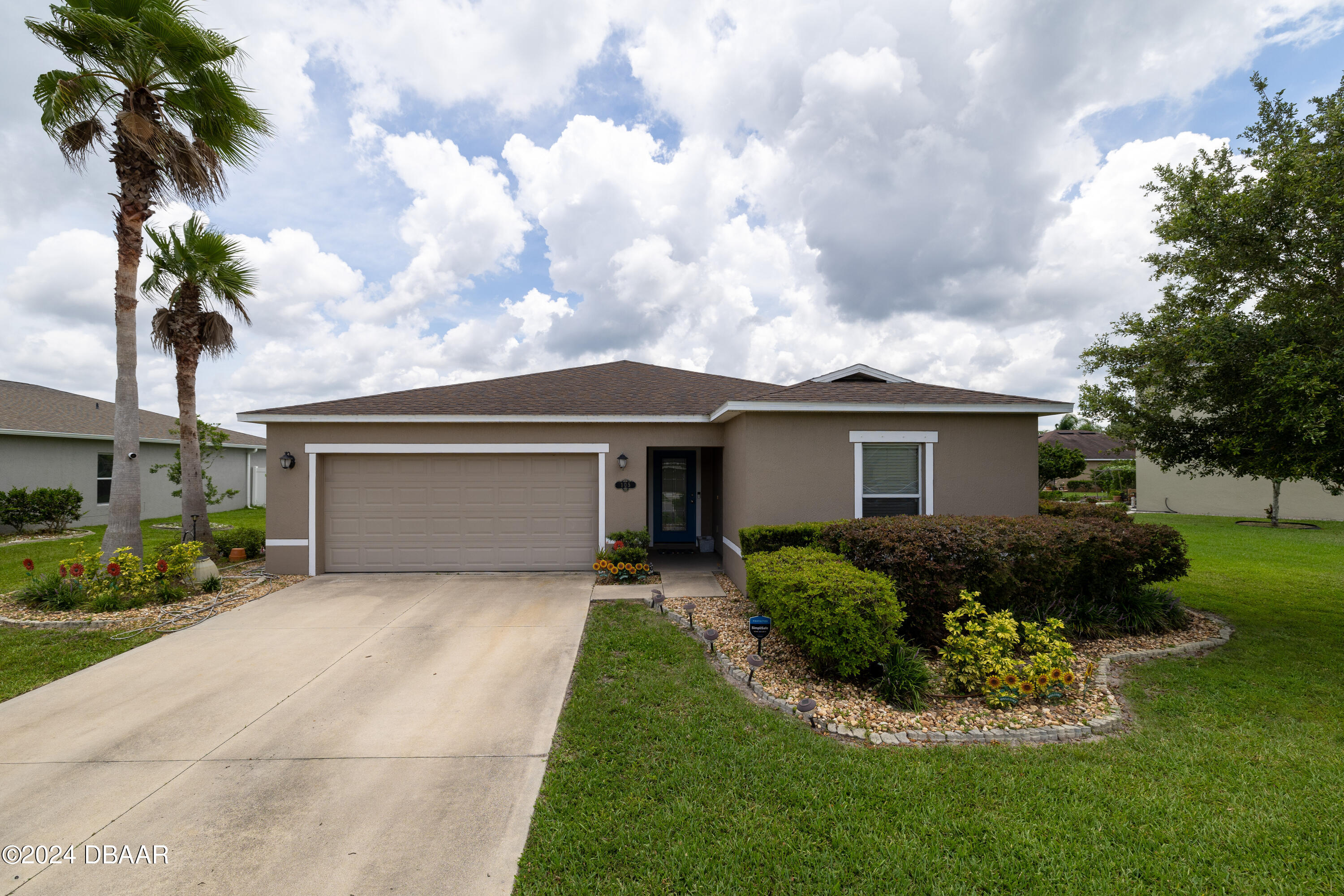 a front view of house with yard and green space