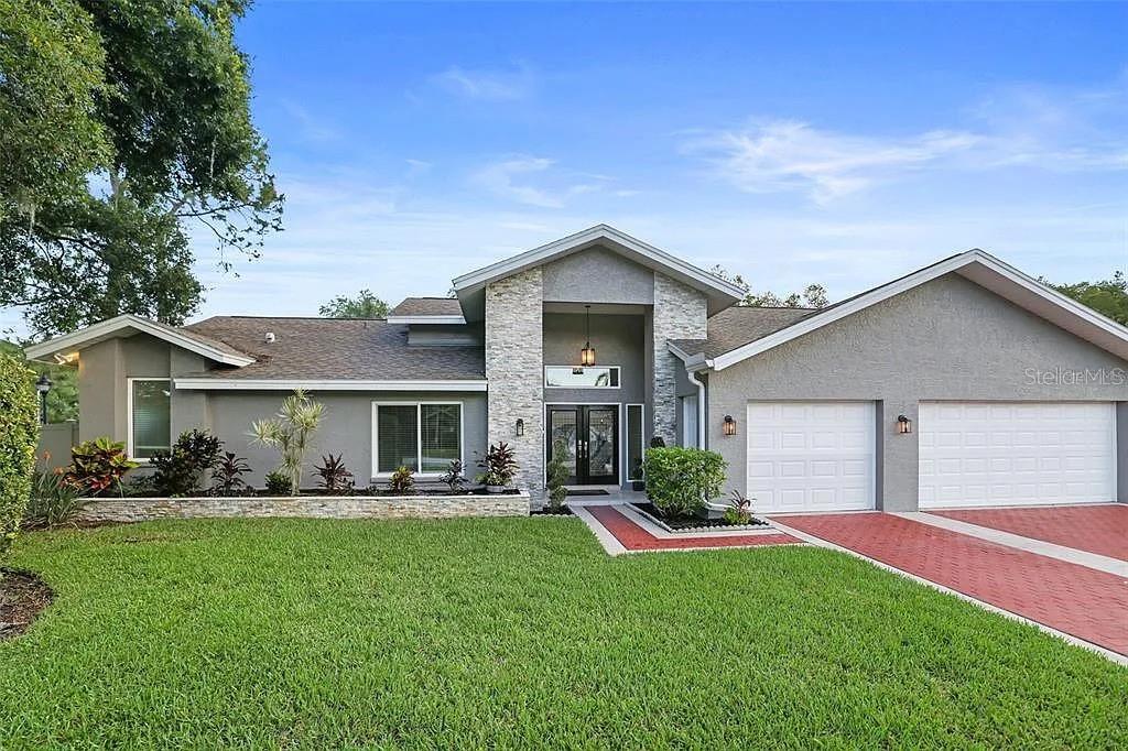 a front view of house with yard and green space