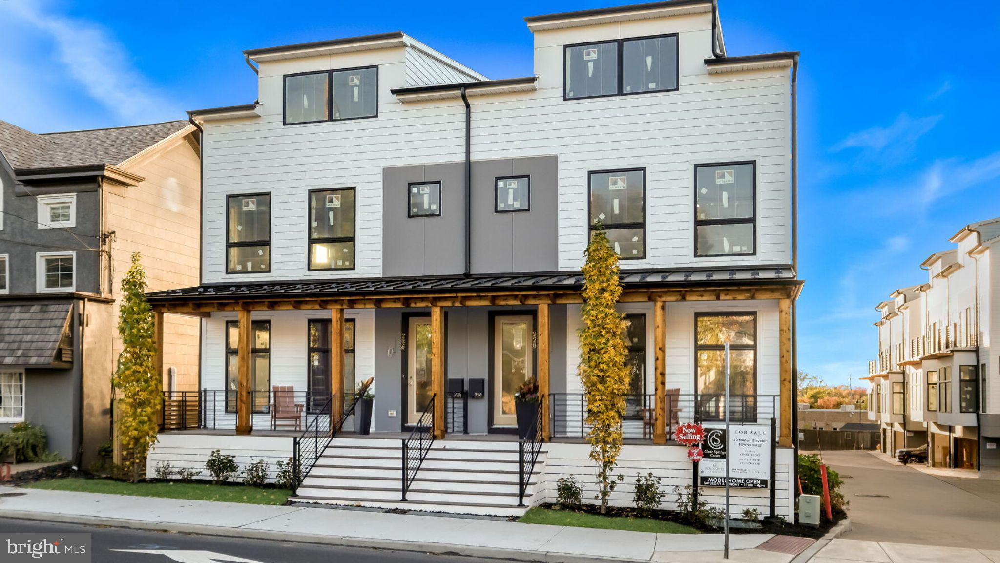 a front view of a residential apartment building with a yard