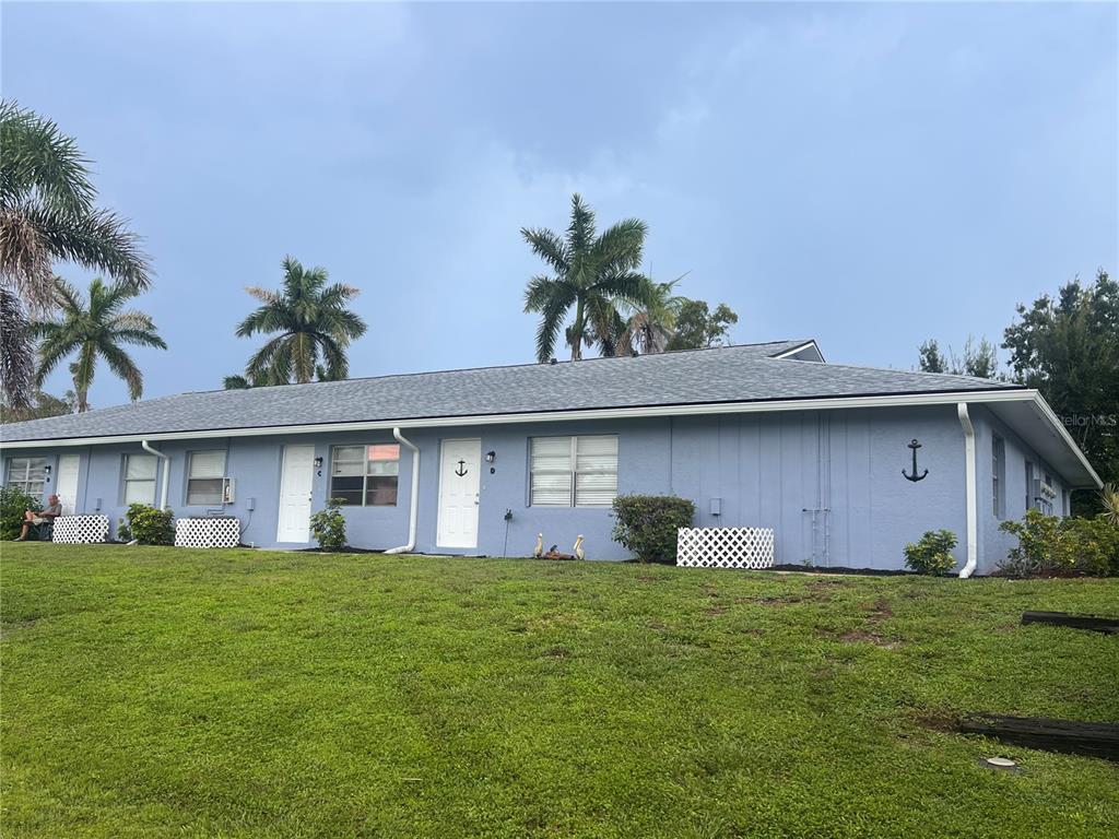 a front view of house with a garden