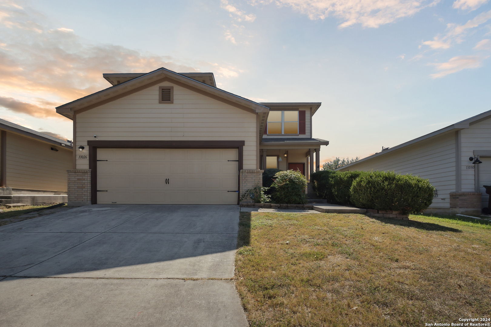 a front view of a house with a yard and garage