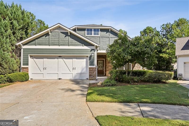 a front view of a house with a yard and garage