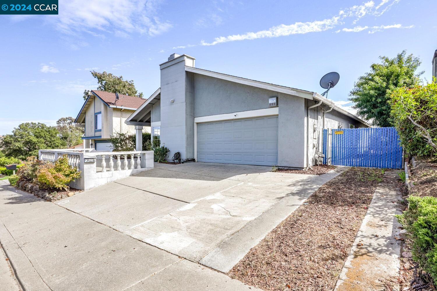 a front view of a house with a yard and a garage