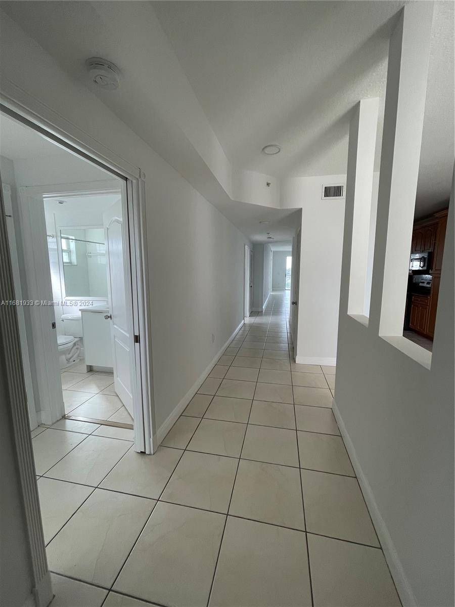 a view of an empty room and a bathroom