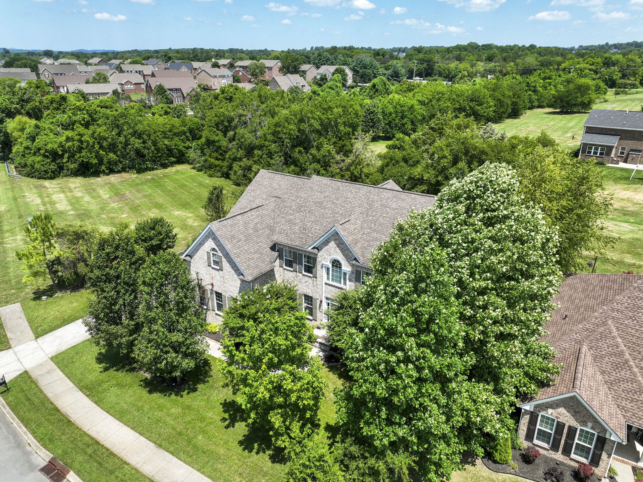 an aerial view of a house with yard and outdoor seating