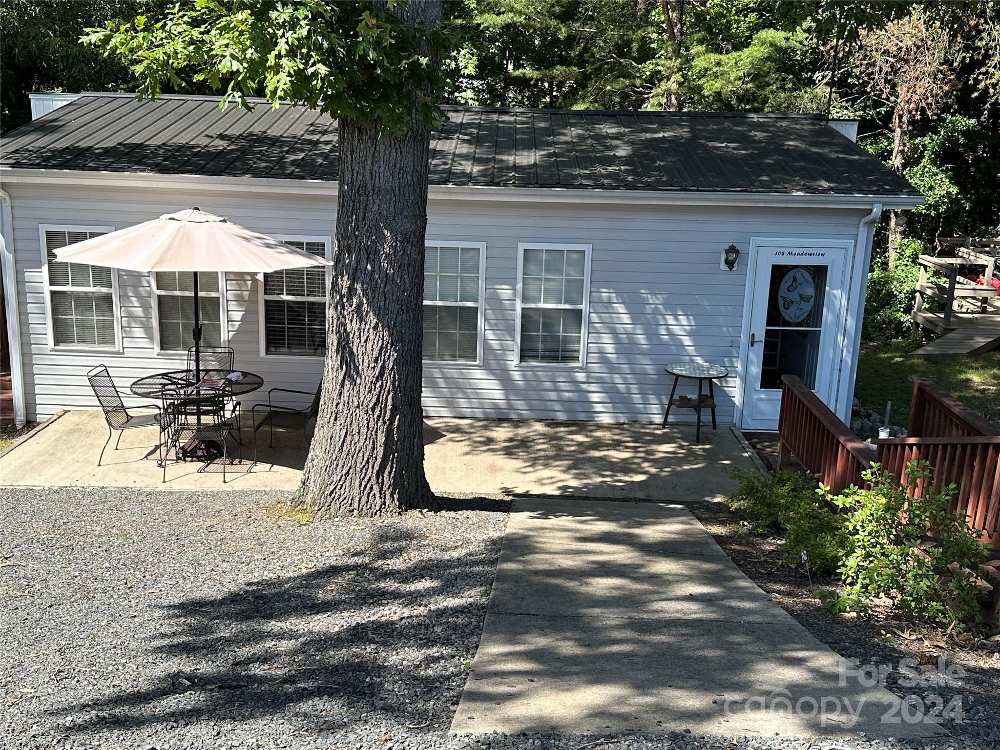 a view of a house with backyard and sitting area