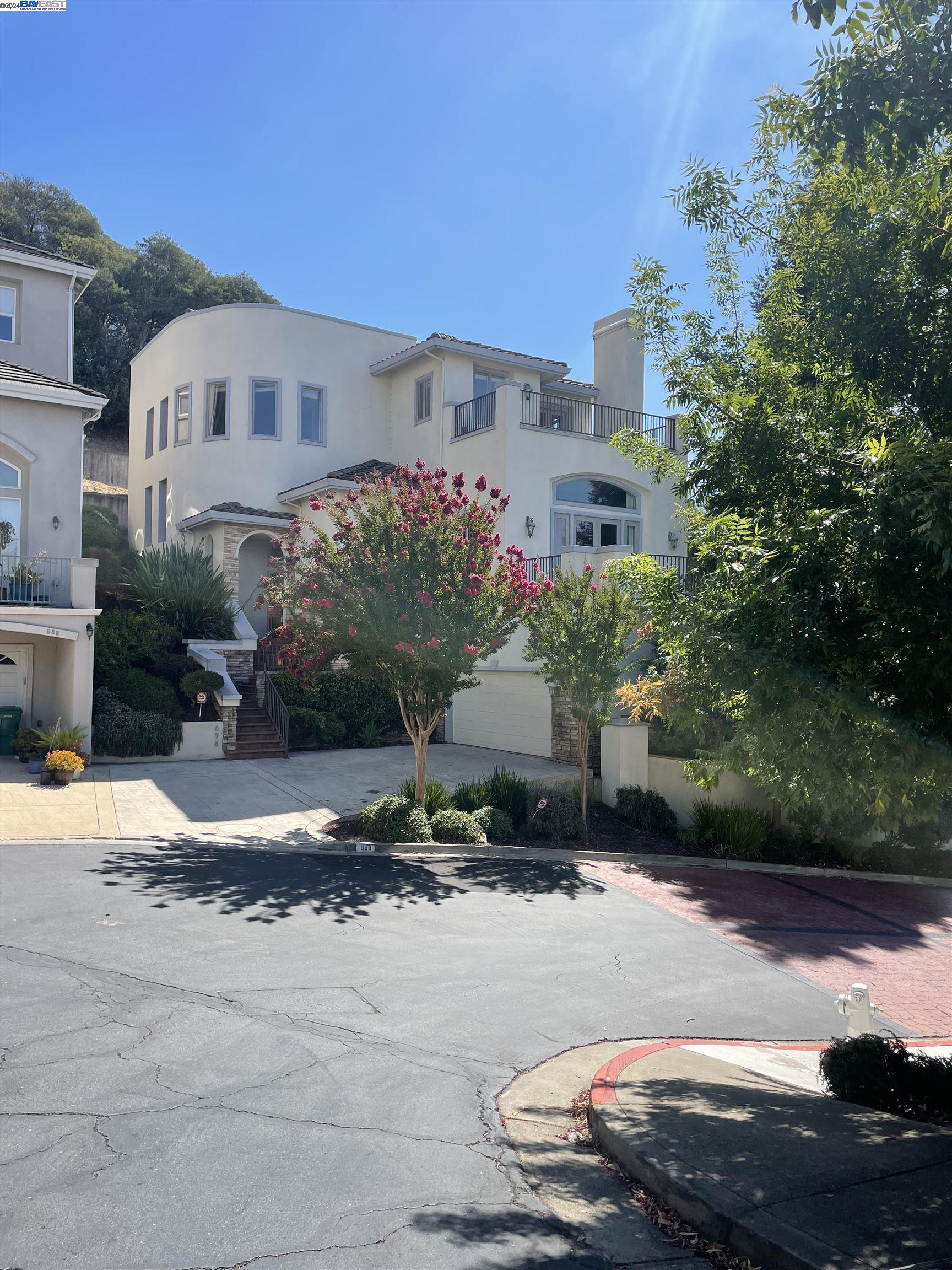 a front view of a house with a yard and a garage