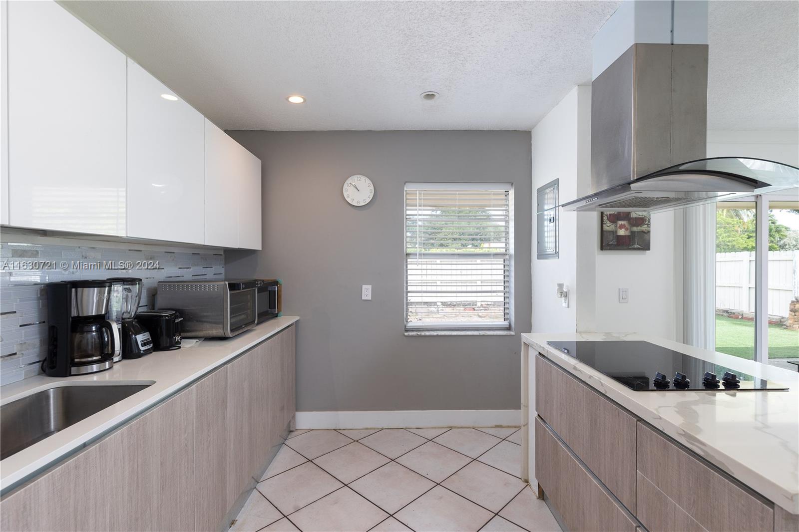 a kitchen with stainless steel appliances granite countertop a sink a stove and a refrigerator