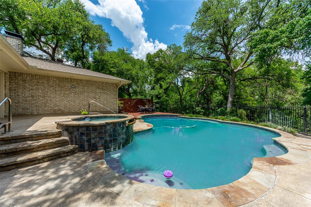 a view of a swimming pool with a patio