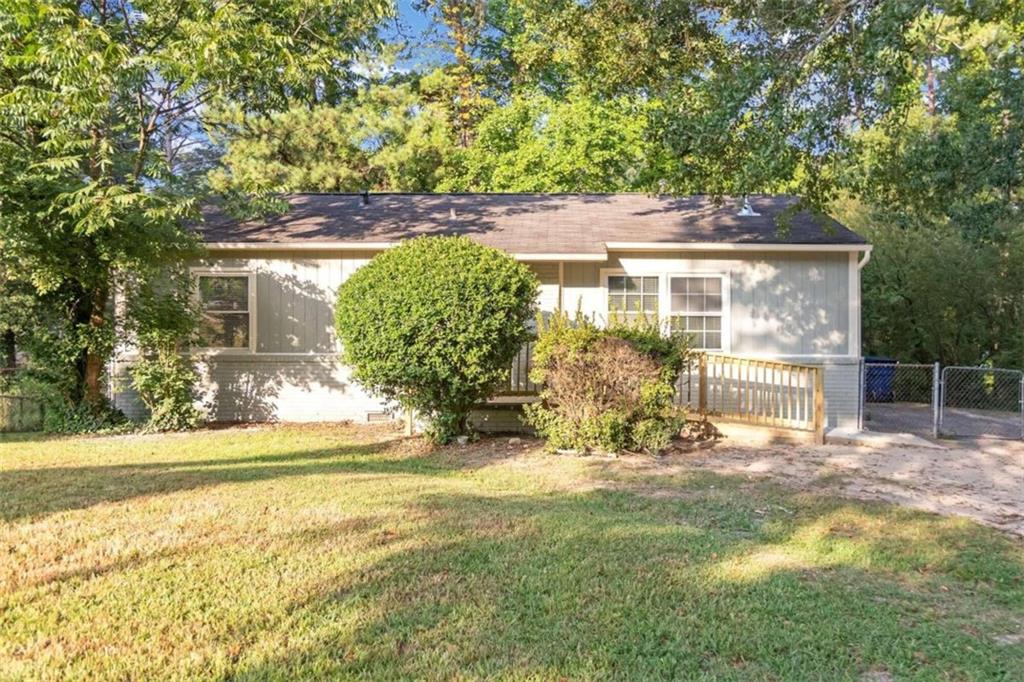 a view of a house with backyard and sitting area