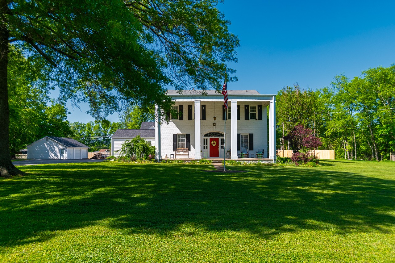 a front view of a house with a garden