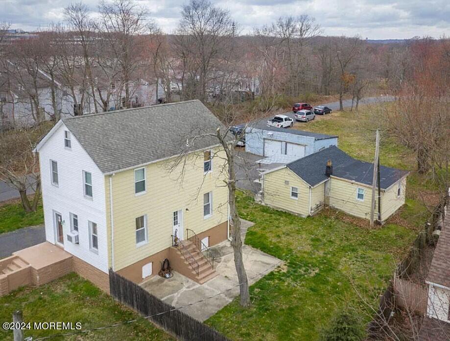 a aerial view of a house with a yard and large tree