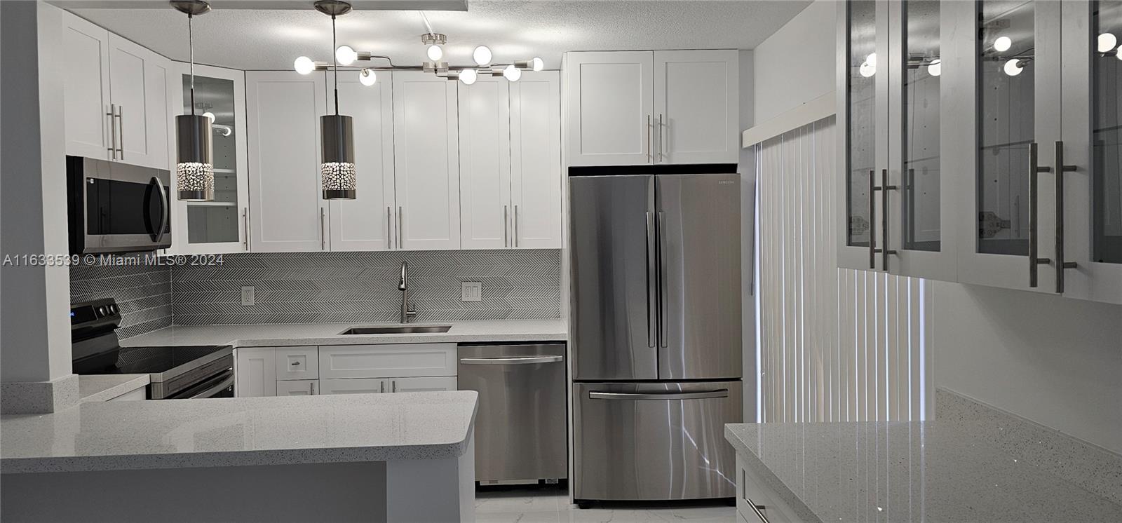 a kitchen with stainless steel appliances a refrigerator and a sink