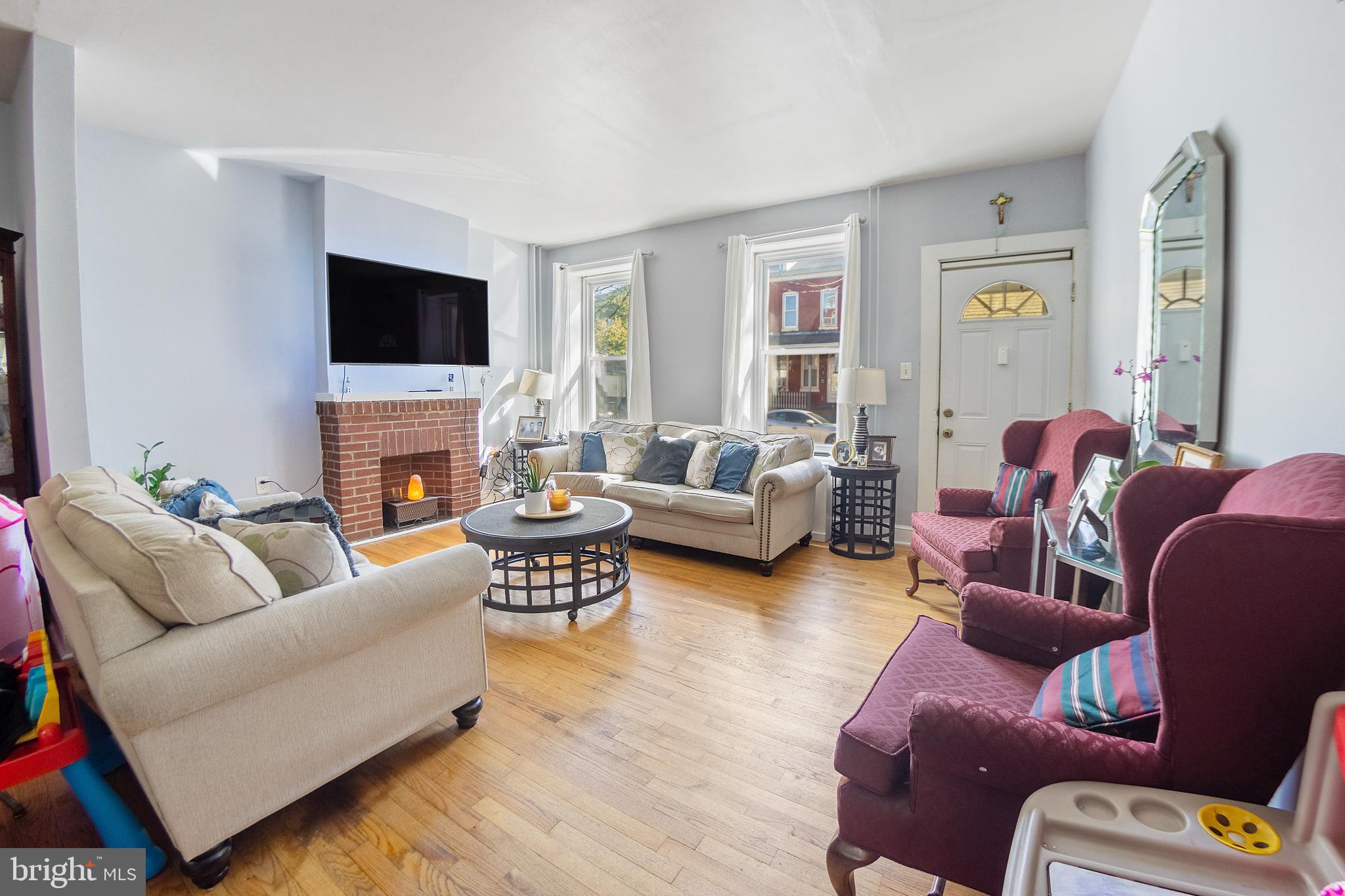 a living room with furniture fireplace and a flat screen tv