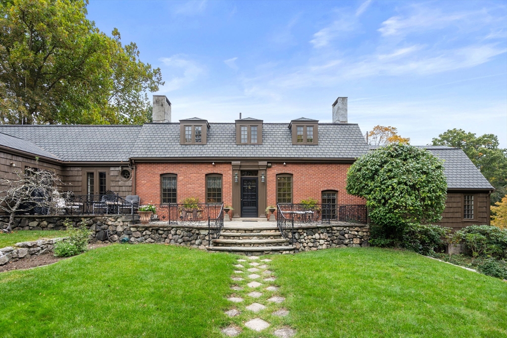 a front view of house with yard and outdoor seating