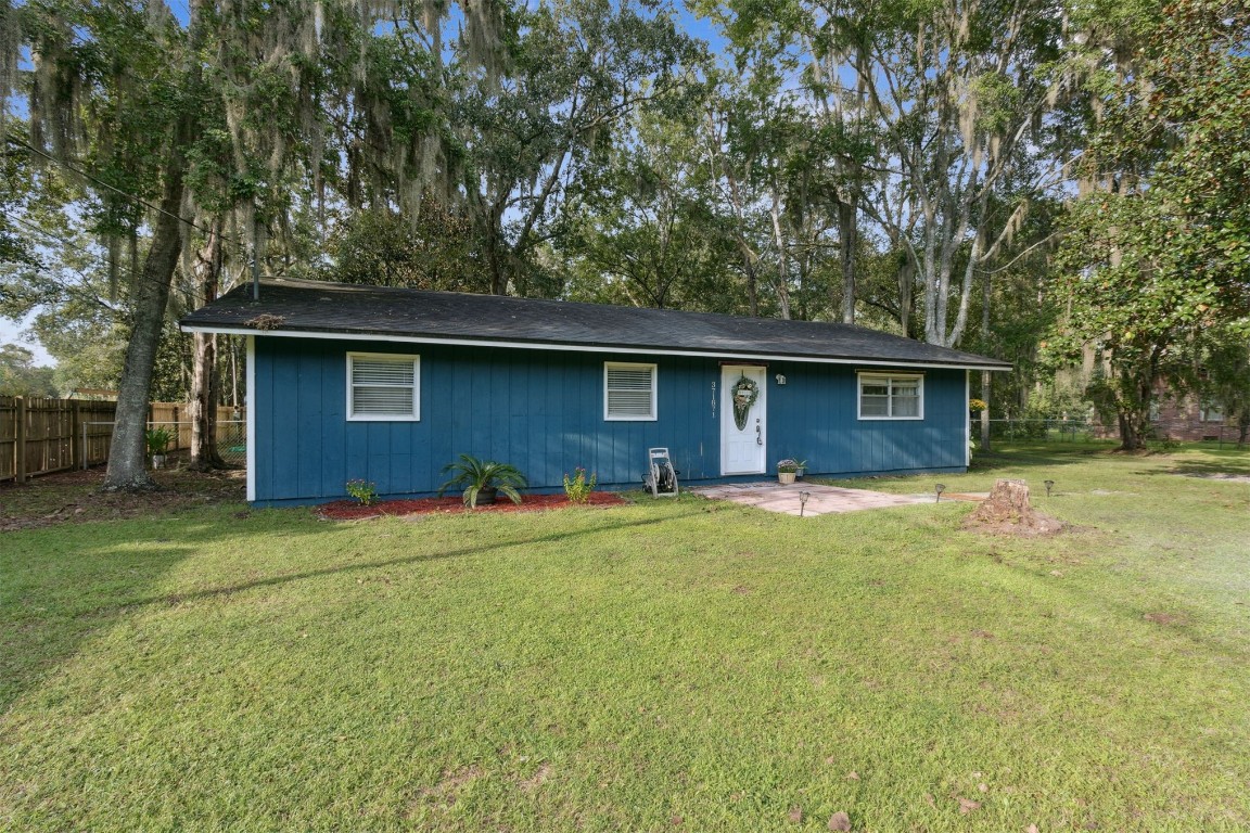 a house that has a tree in front of it