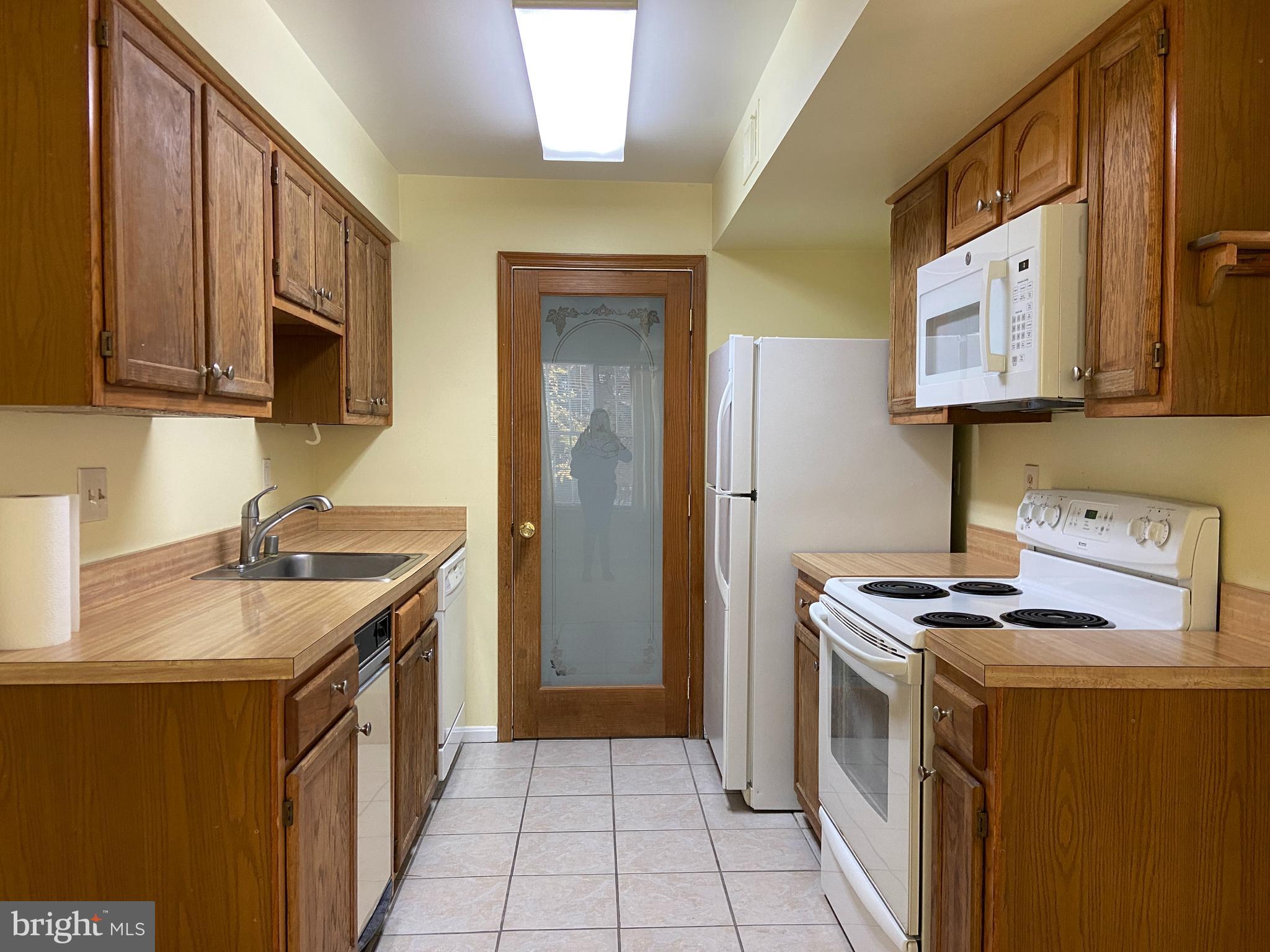 a kitchen with a sink stove top oven and cabinets