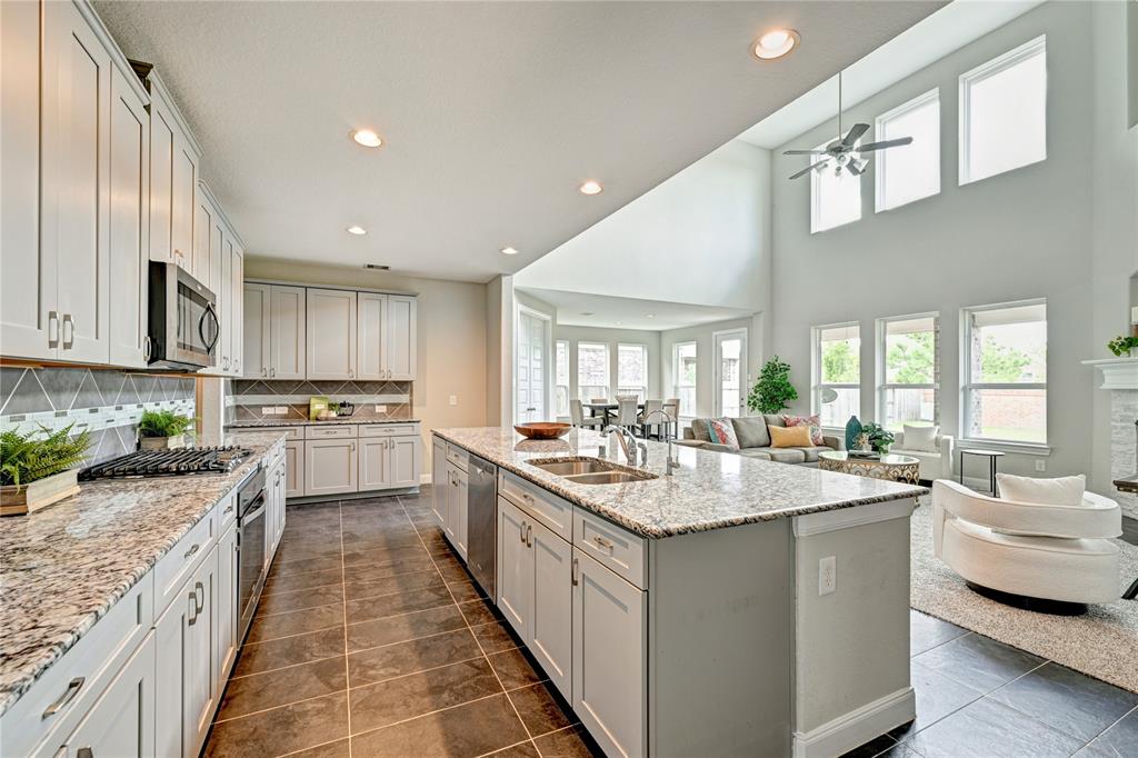 a kitchen with sink stove and cabinets