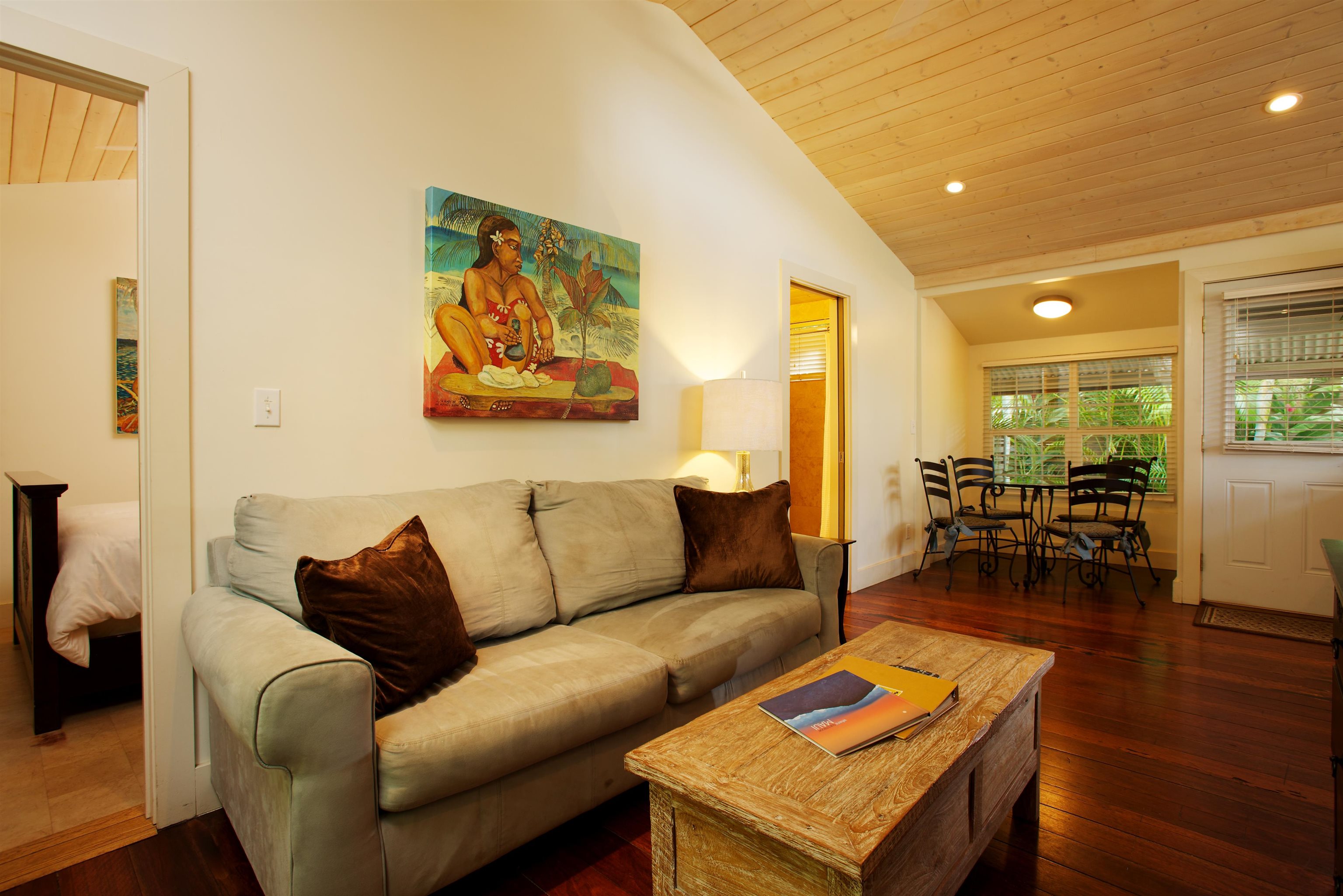 a living room with furniture and a table with wooden floor