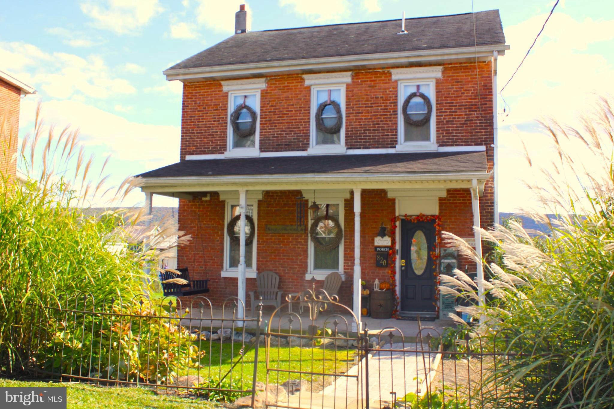 a front view of house with a garden