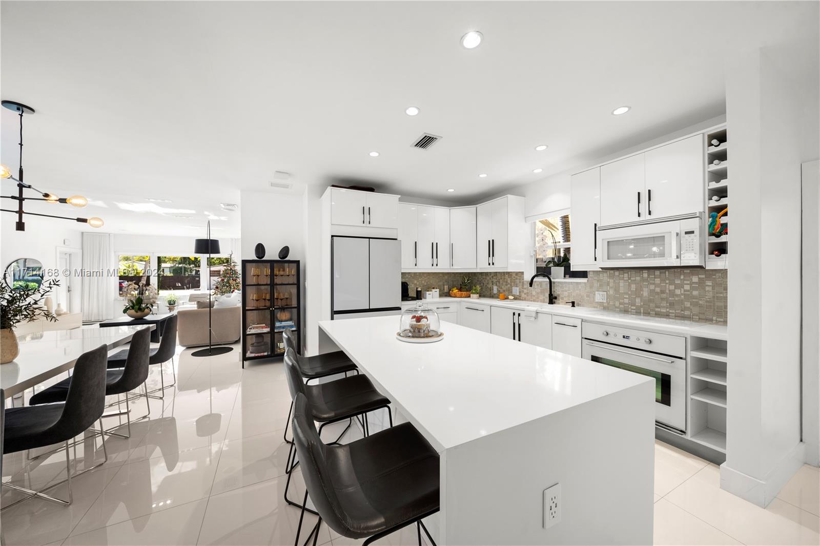 a kitchen with a sink a stove and chairs