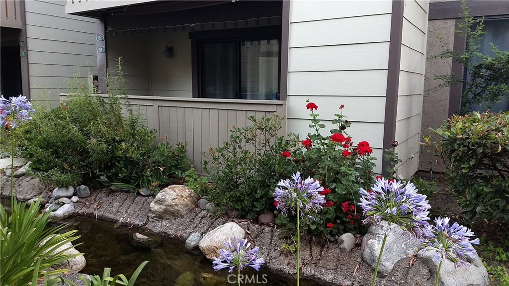 a view of a house with a flower garden