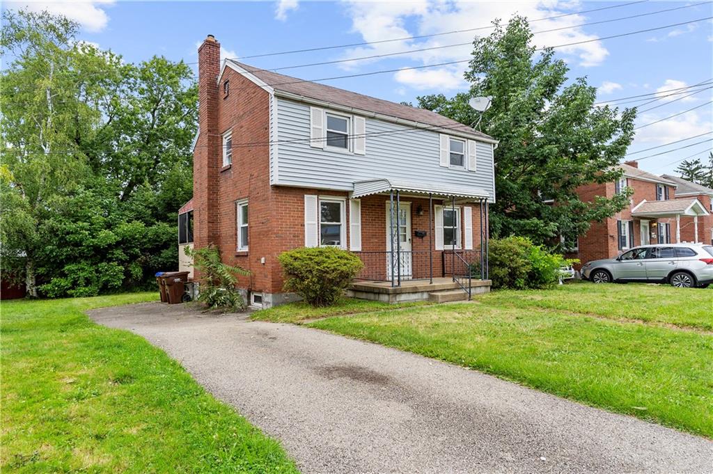 a front view of a house with a yard and porch