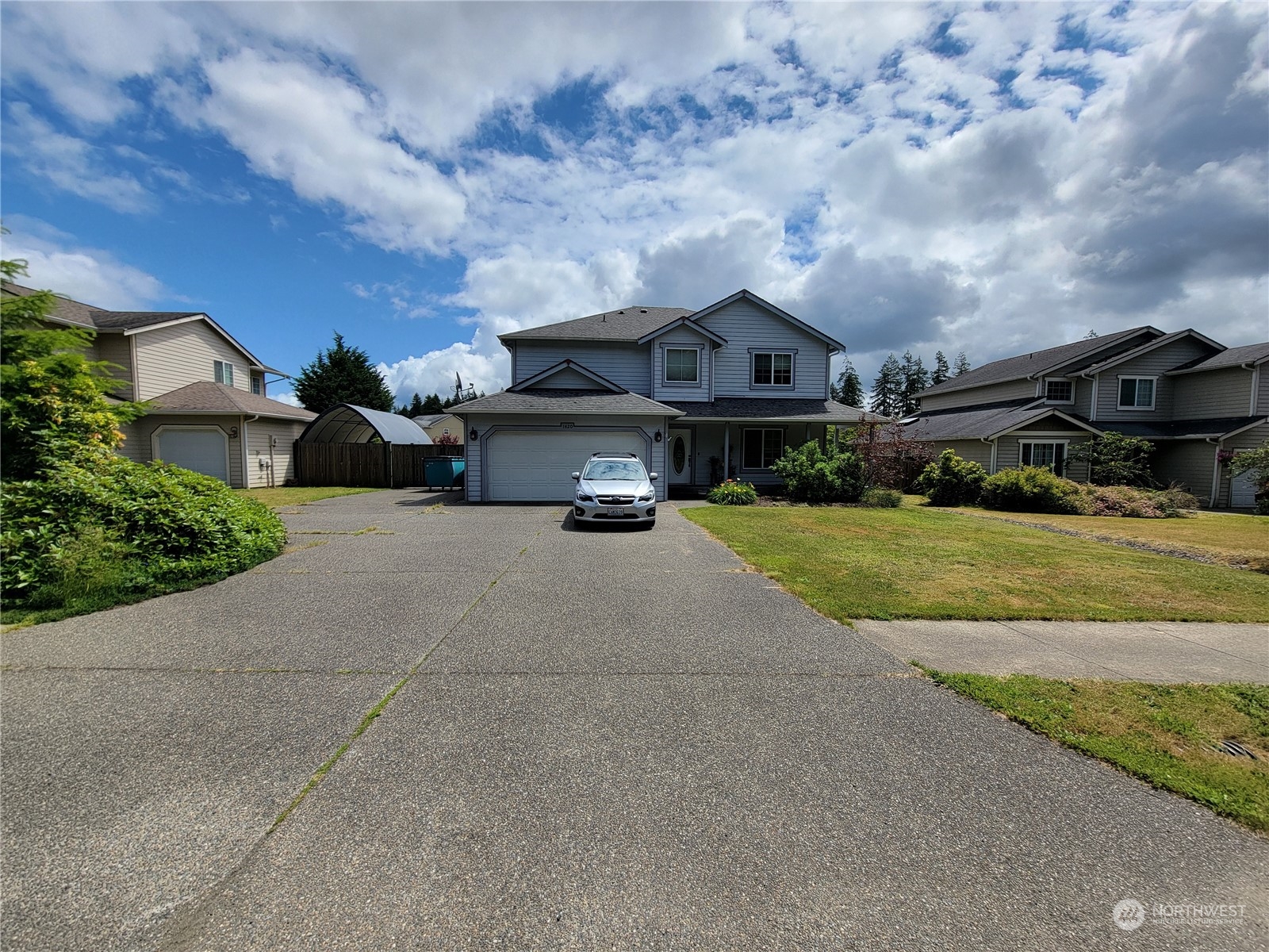 a view of house with yard in front of it