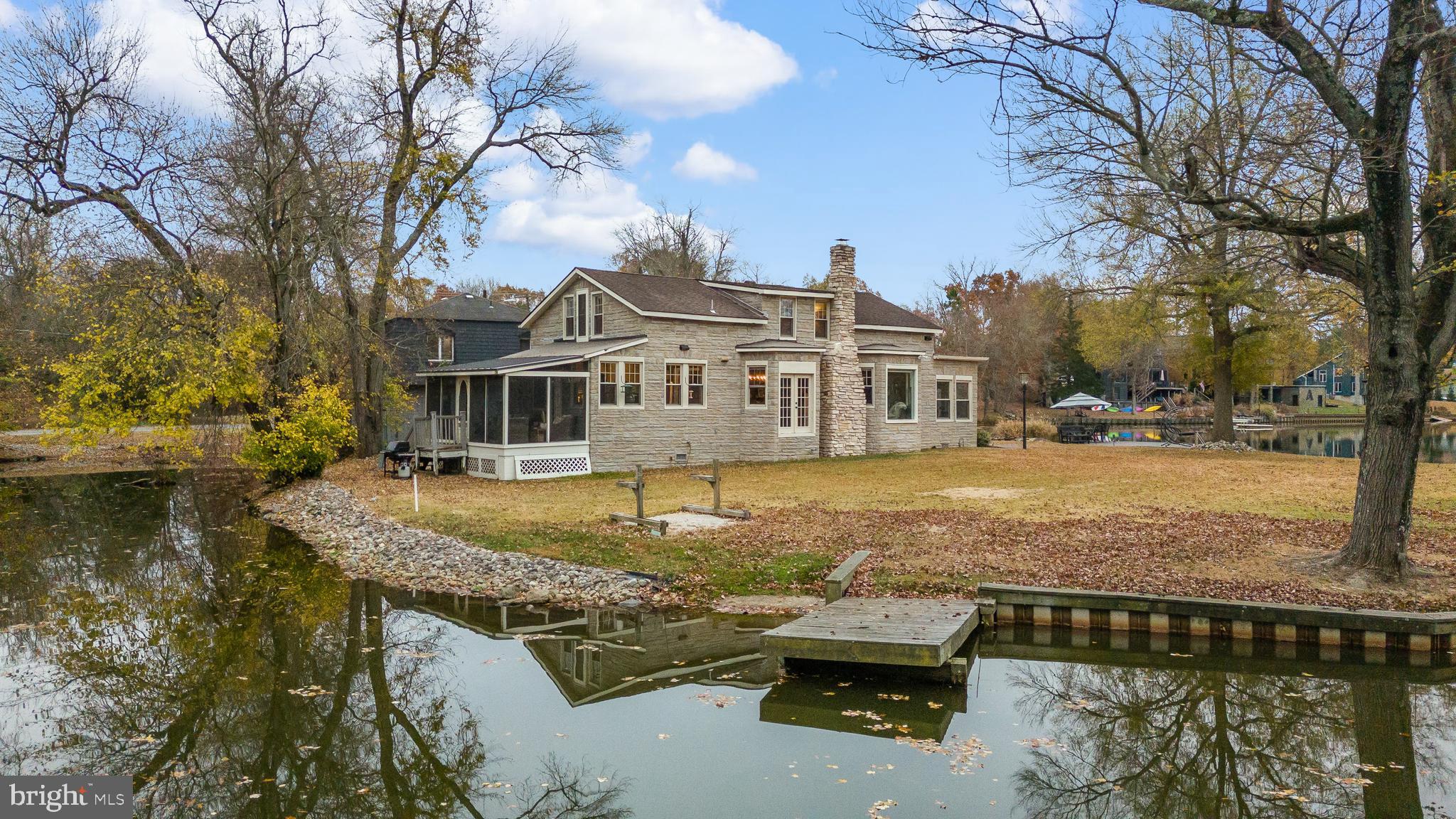 a view of a house with swimming pool next to a yard