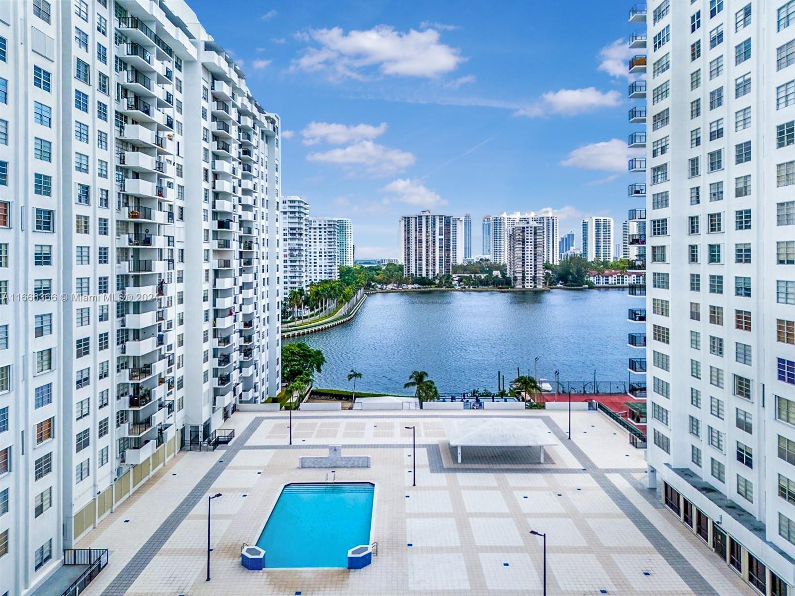 a view of building with outdoor space and lake view