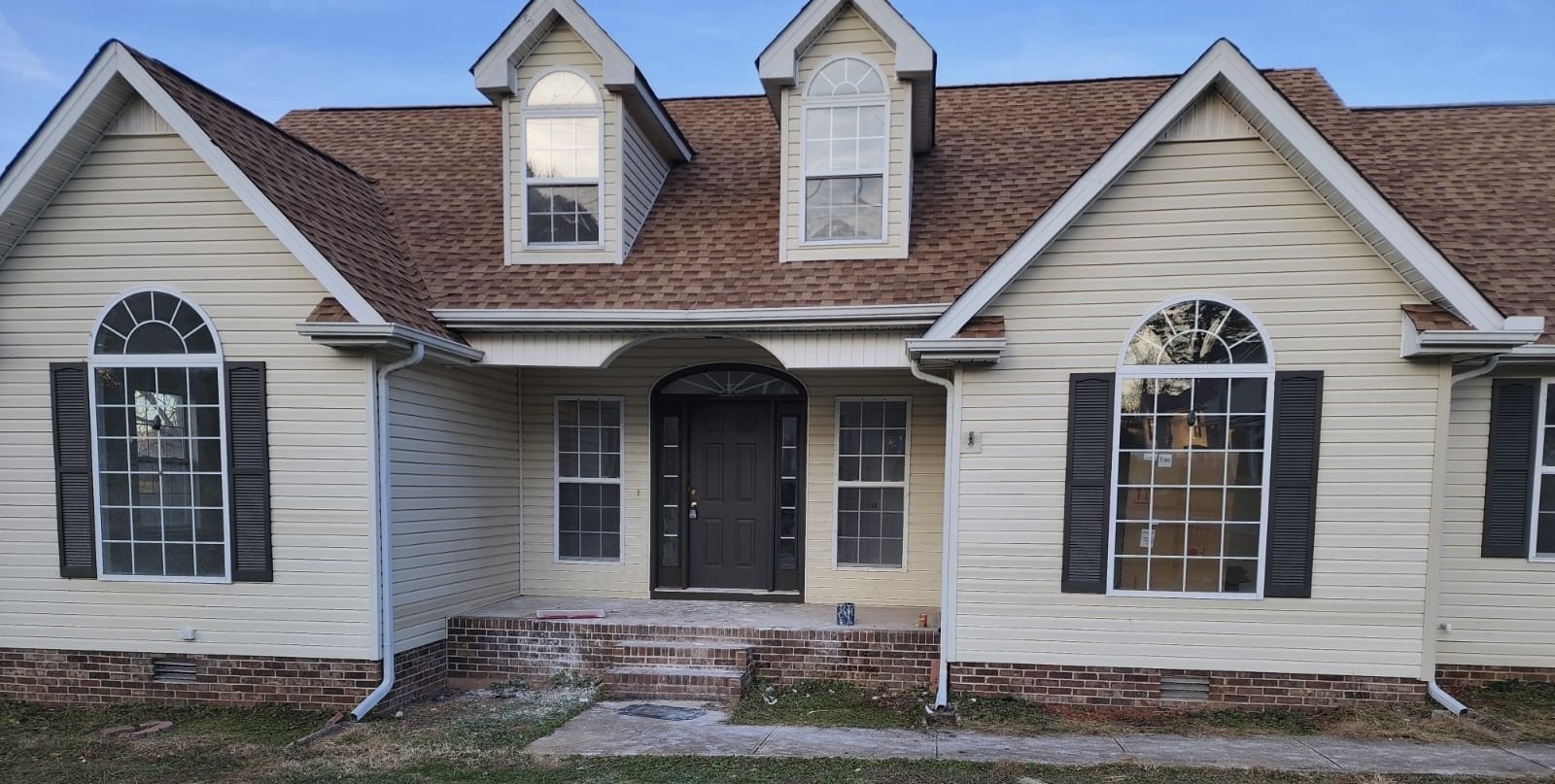 a view of a brick house with many windows