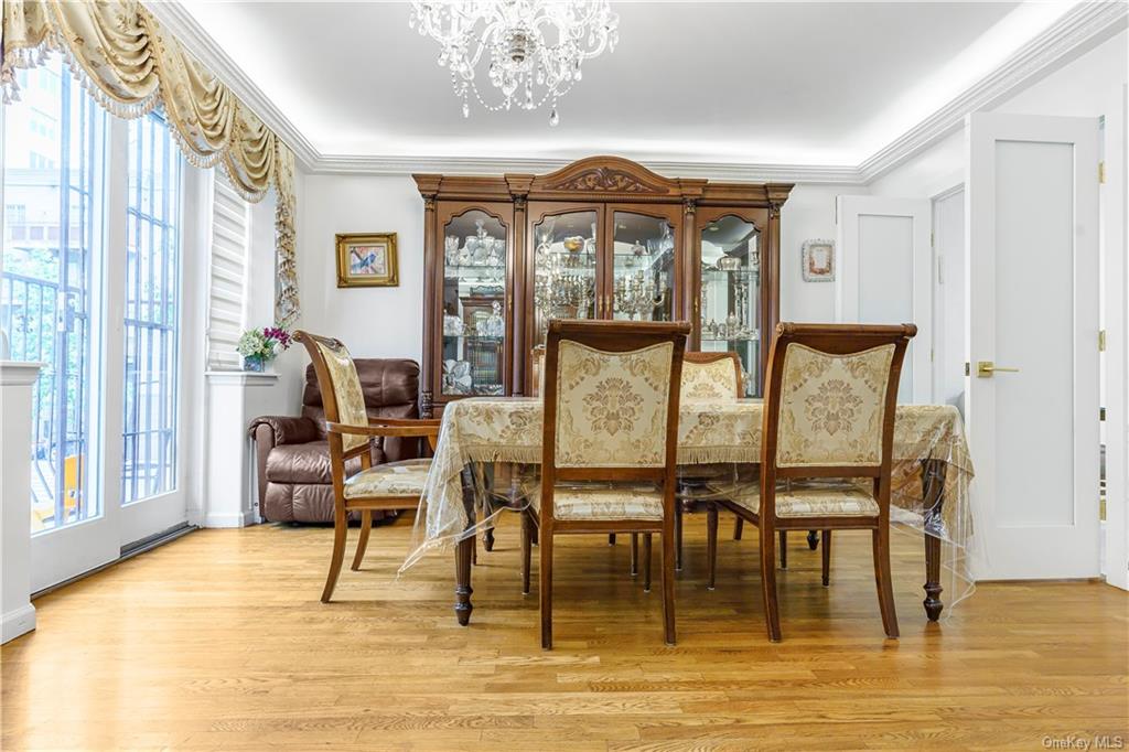 a view of a dining room with furniture a chandelier and wooden floor