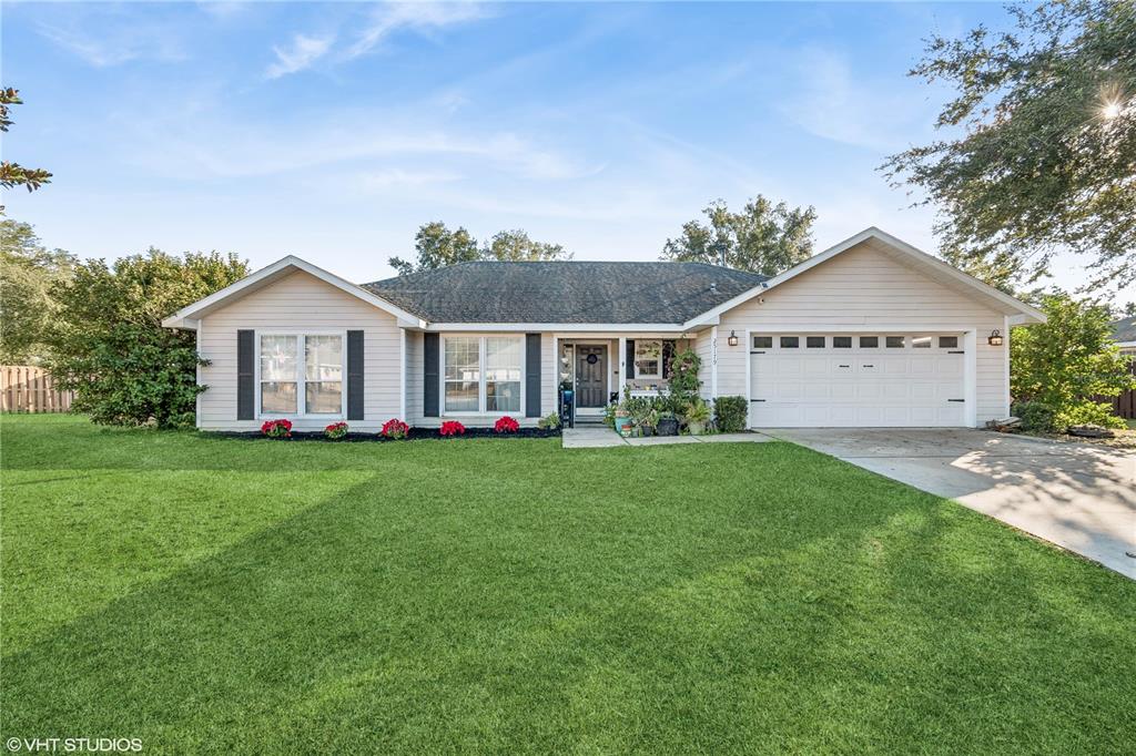 a front view of a house with a yard and garage