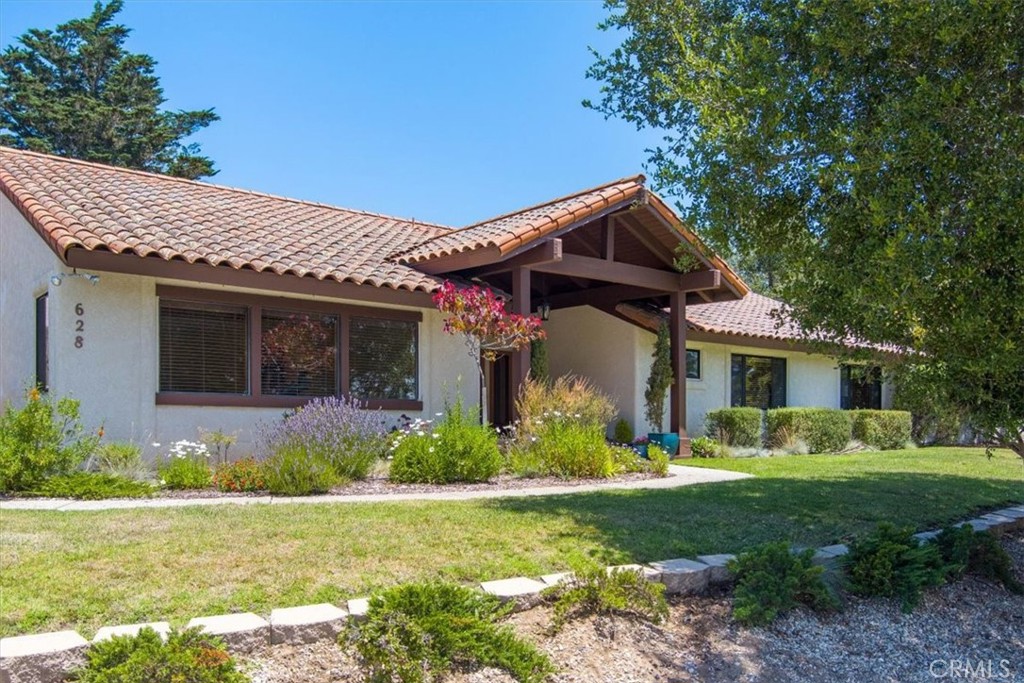 a front view of house with yard and green space