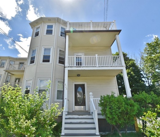 front view of a house with a garden