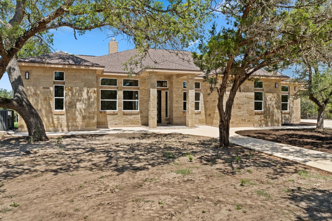 a front view of a house with a garden