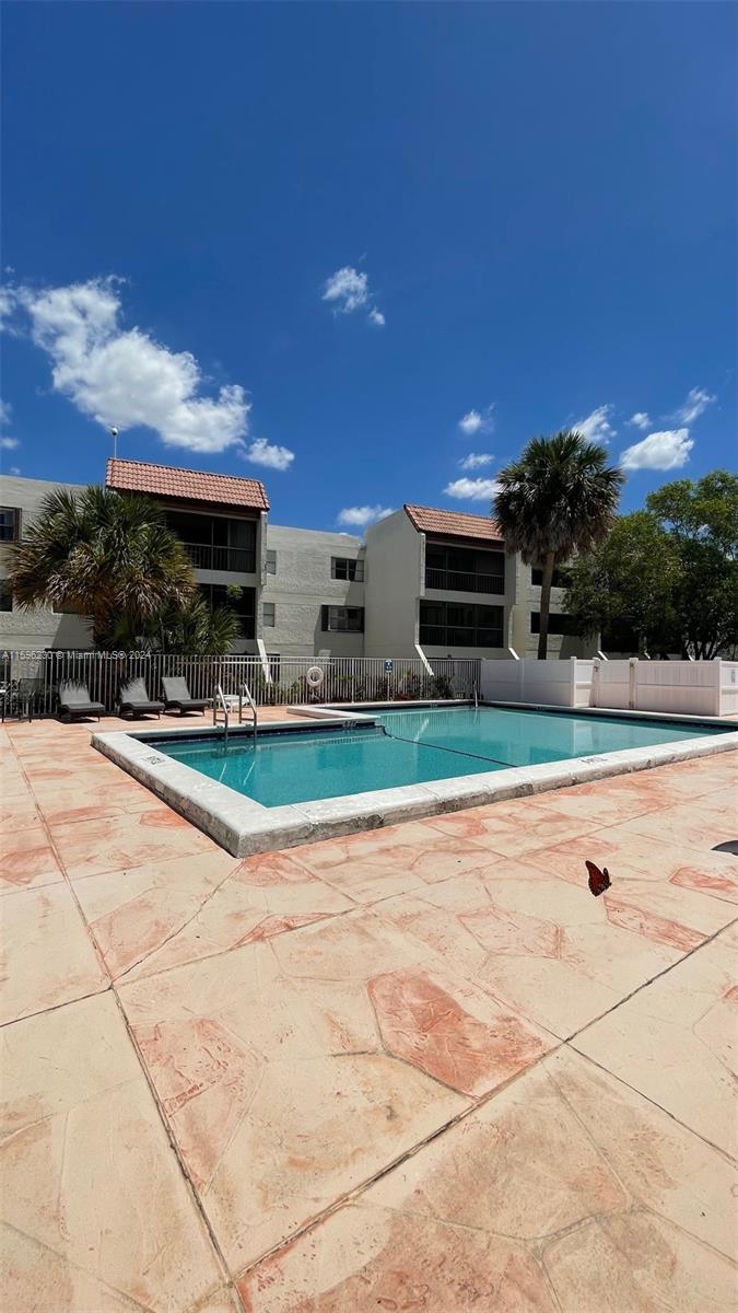 a view of outdoor space with swimming pool and furniture