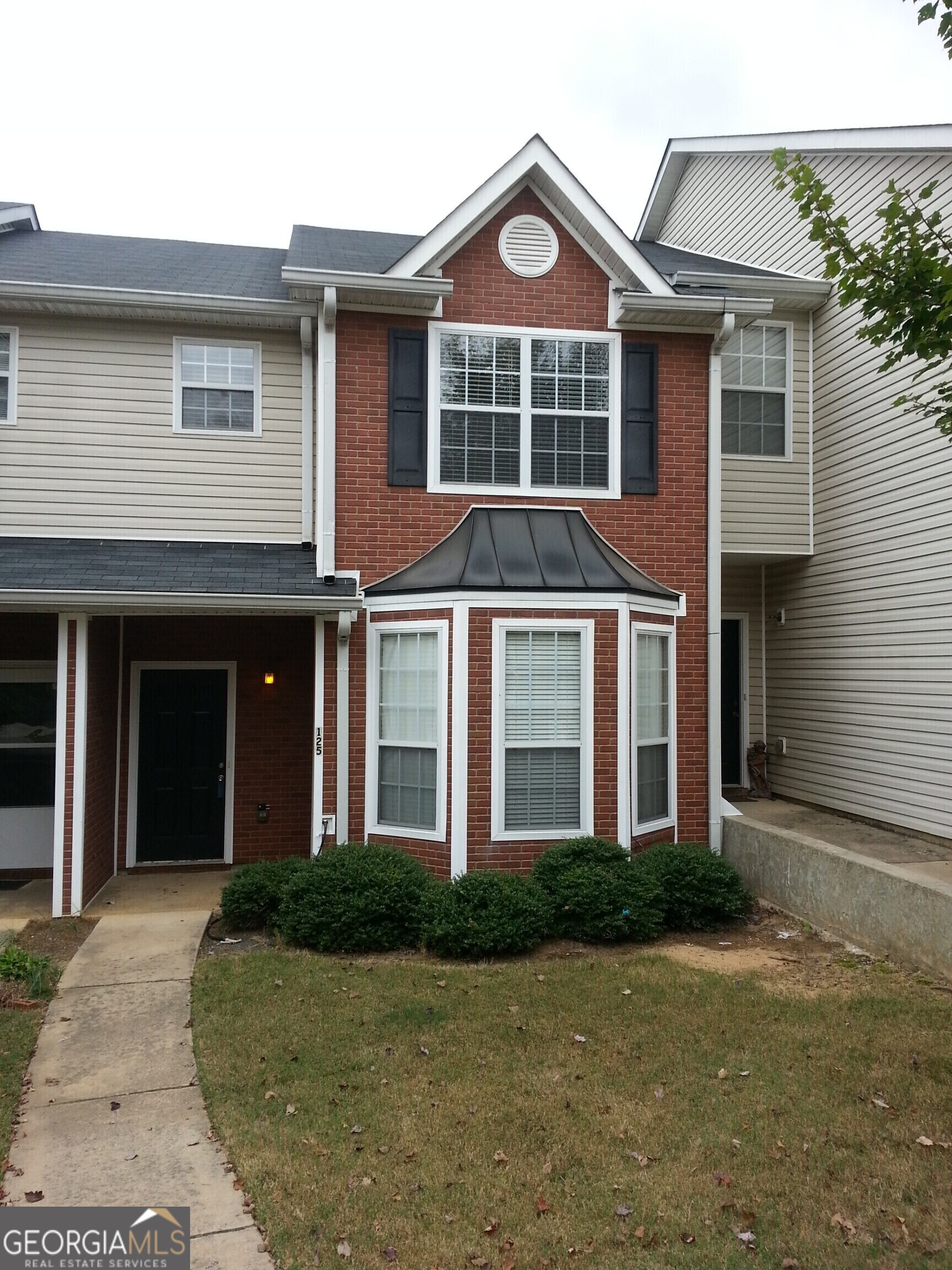 a front view of a house with yard