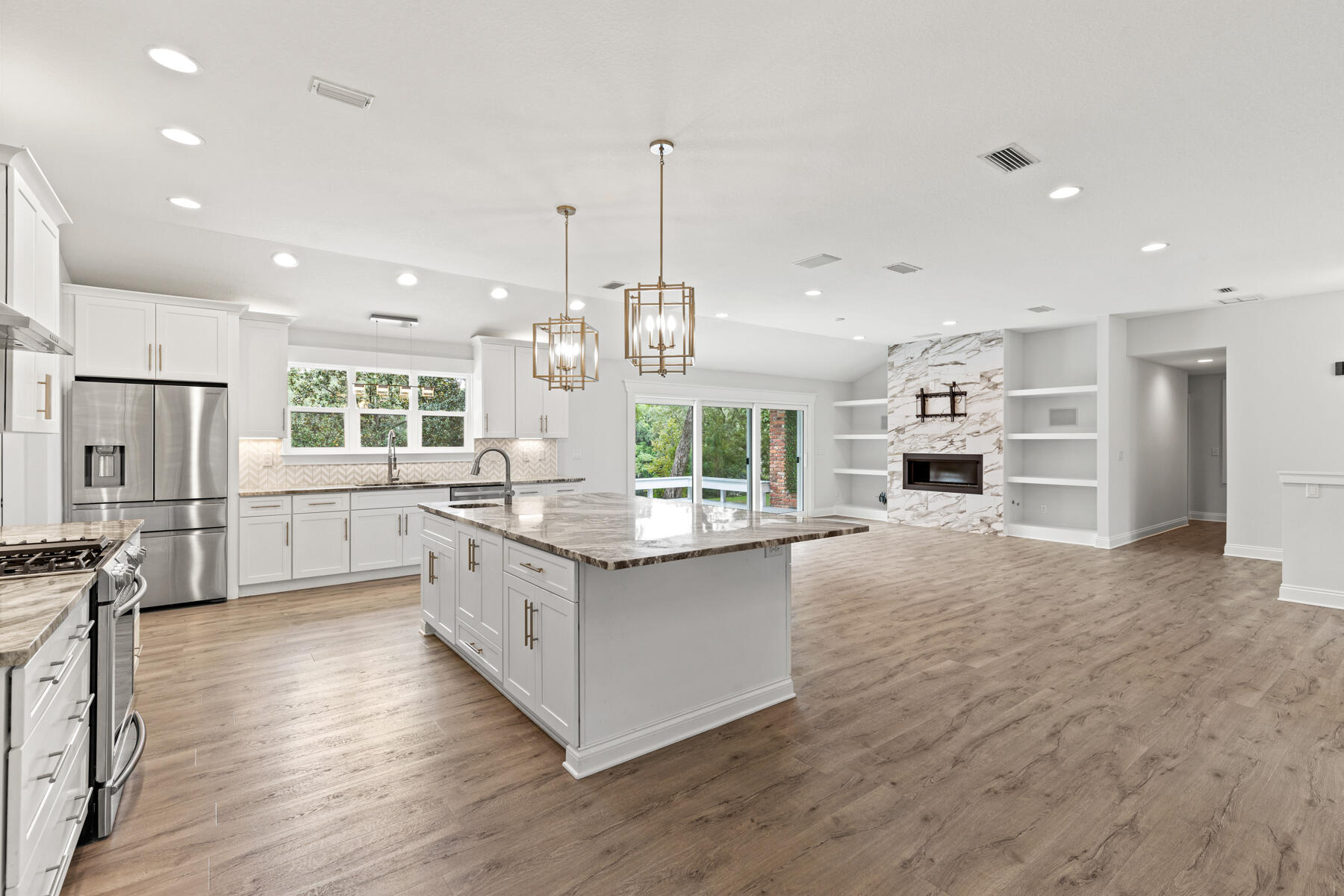 a kitchen with stainless steel appliances granite countertop a stove and a refrigerator