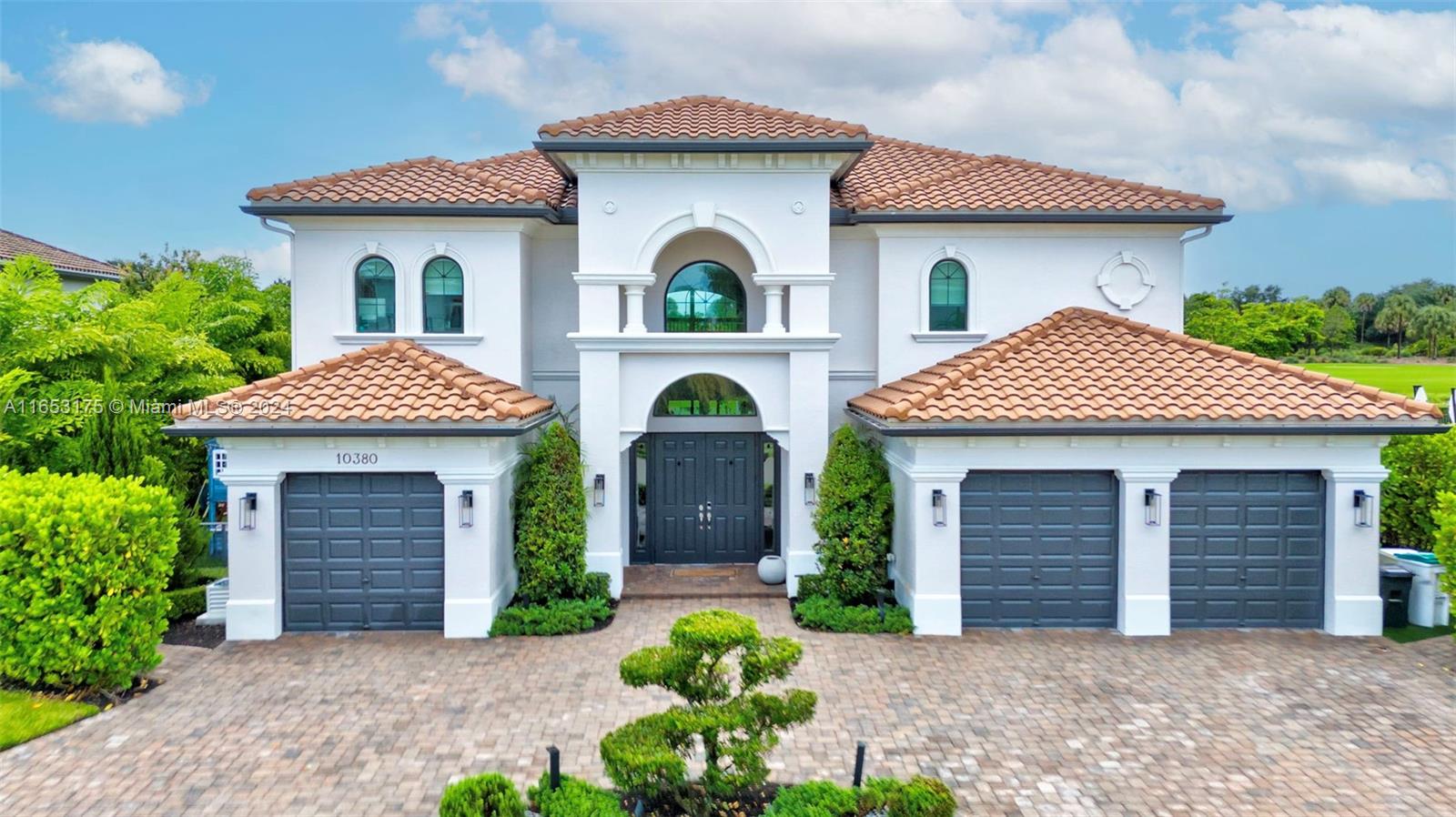 a front view of a house with yard and garage