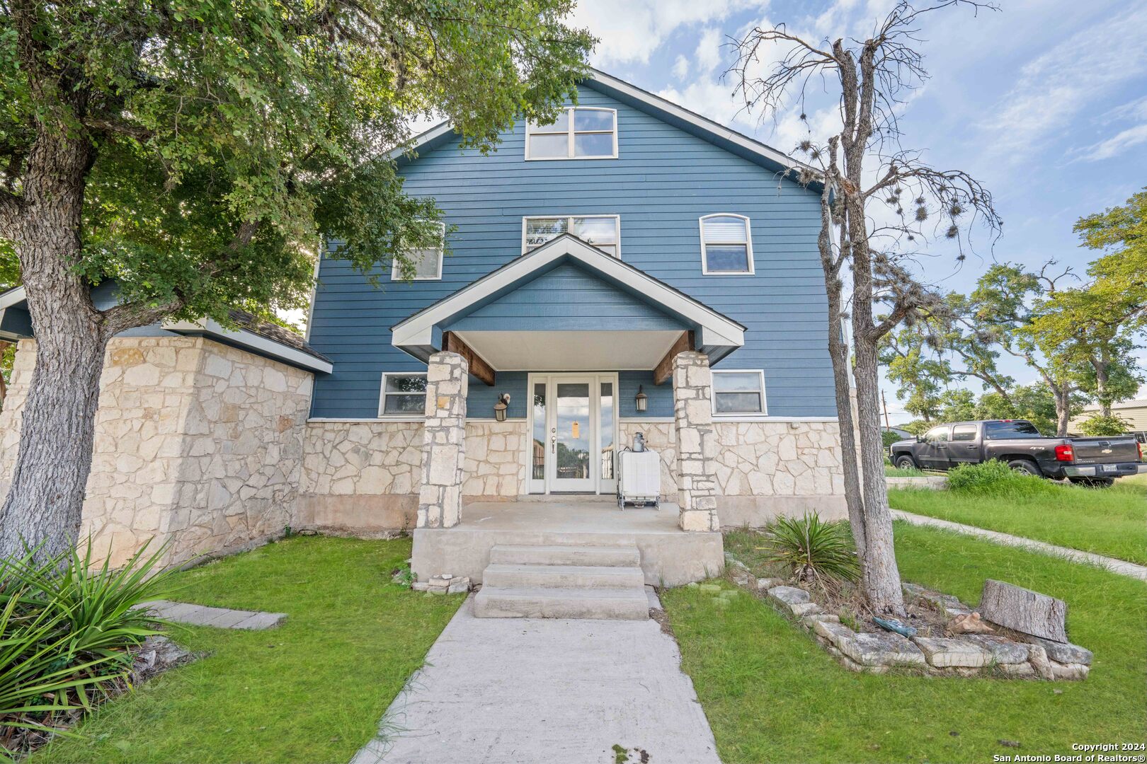 a front view of a house with a yard