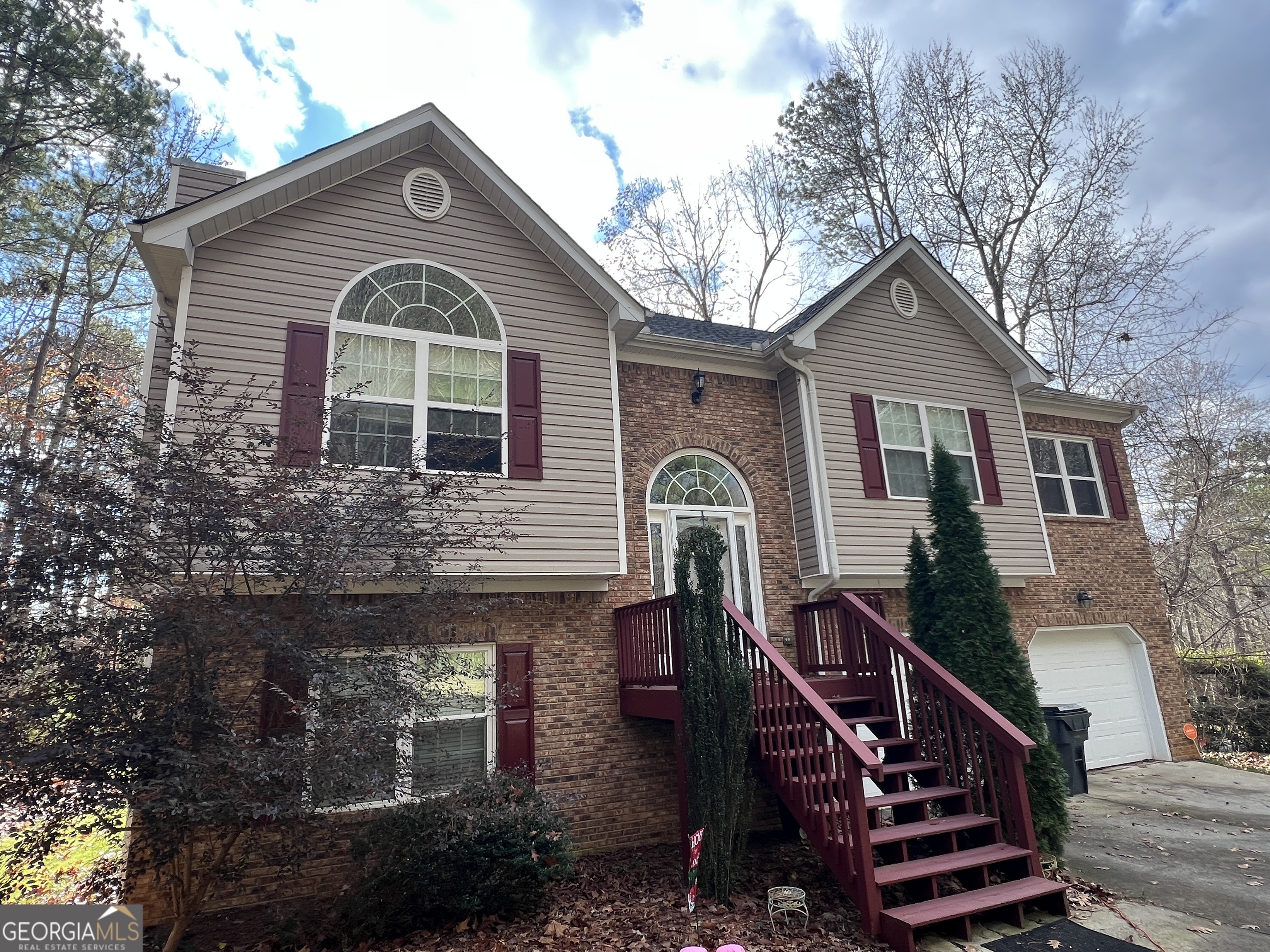 a front view of a house with stairs yard