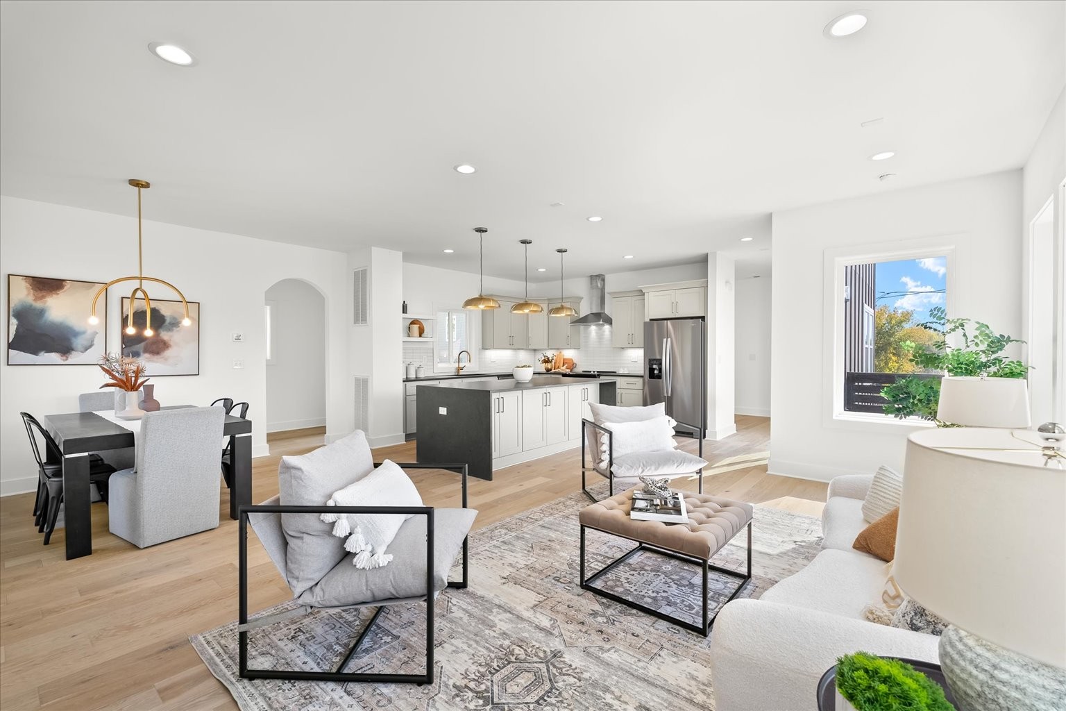 a living room with lots of furniture and kitchen view