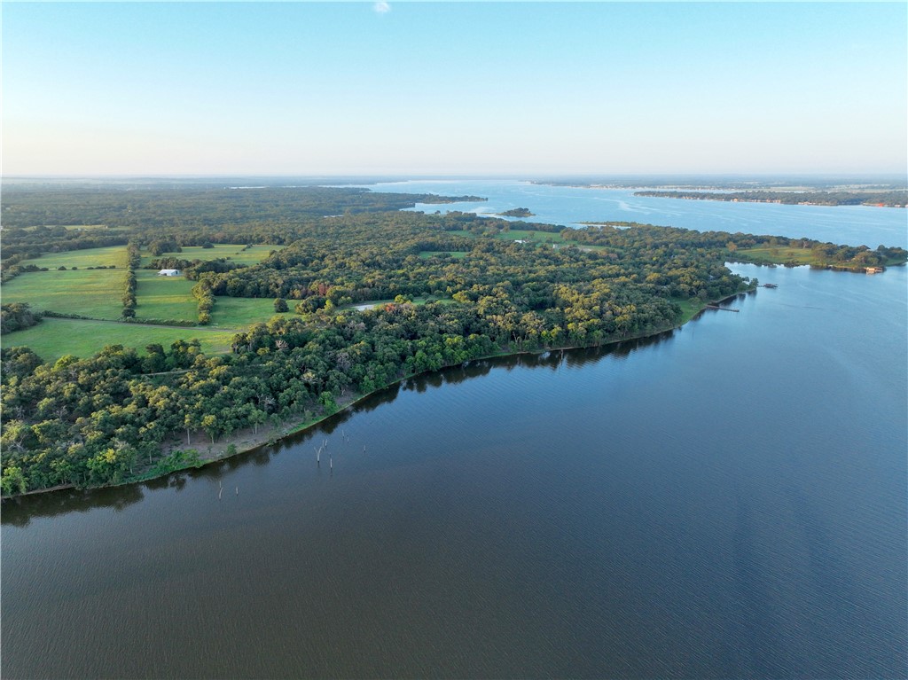 a view of a lake with houses in back