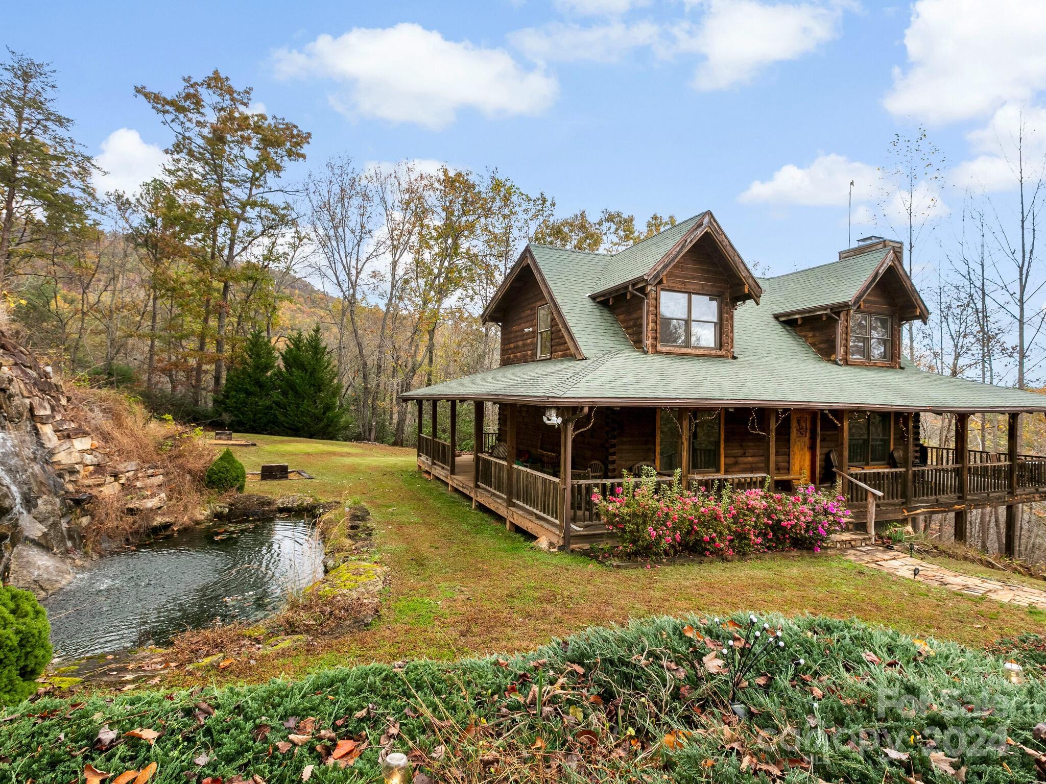 an aerial view of a house with swimming pool garden and patio