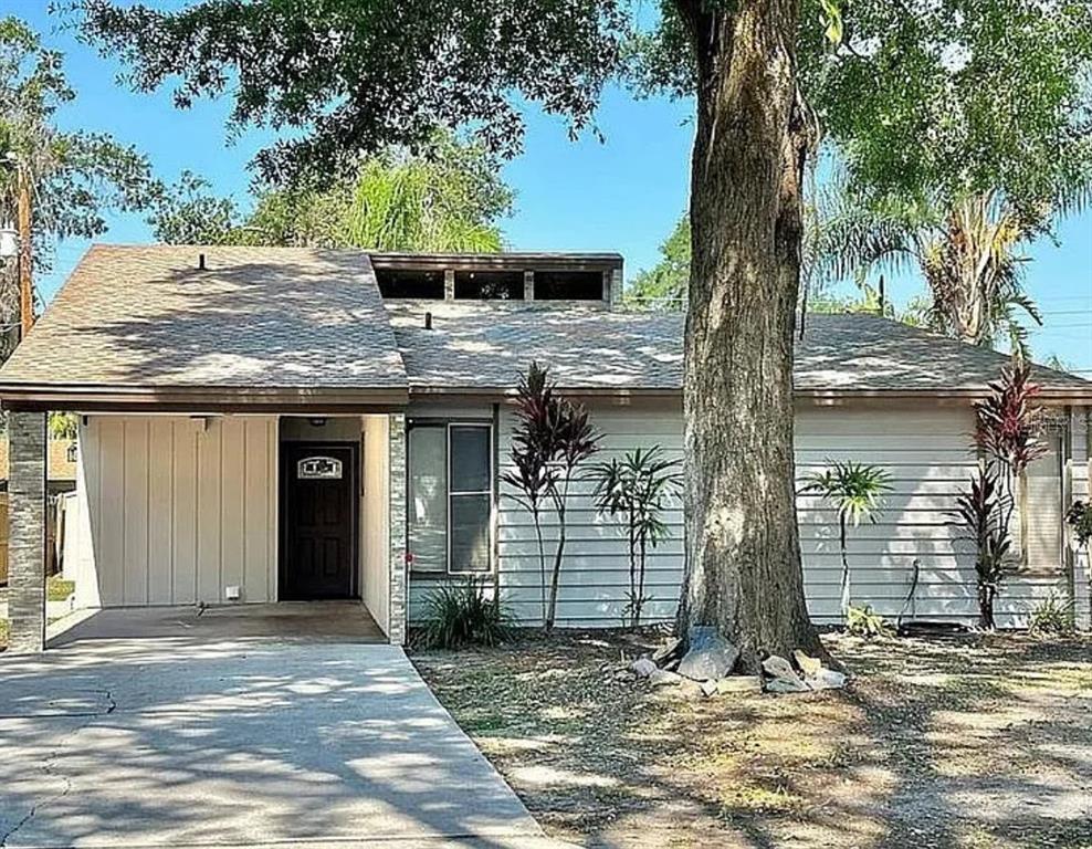 a view of a house with a tree